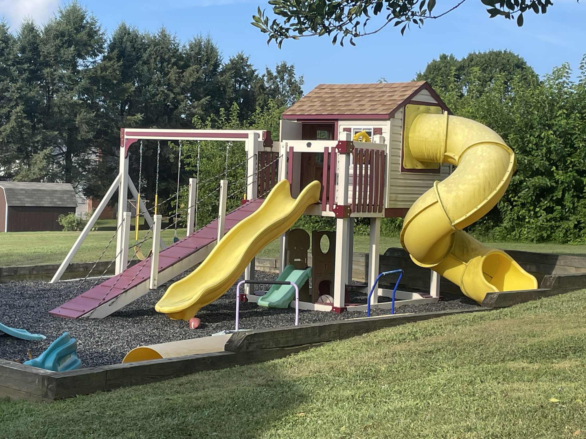 Large outdoor playground with slides, swings, and climbing structures