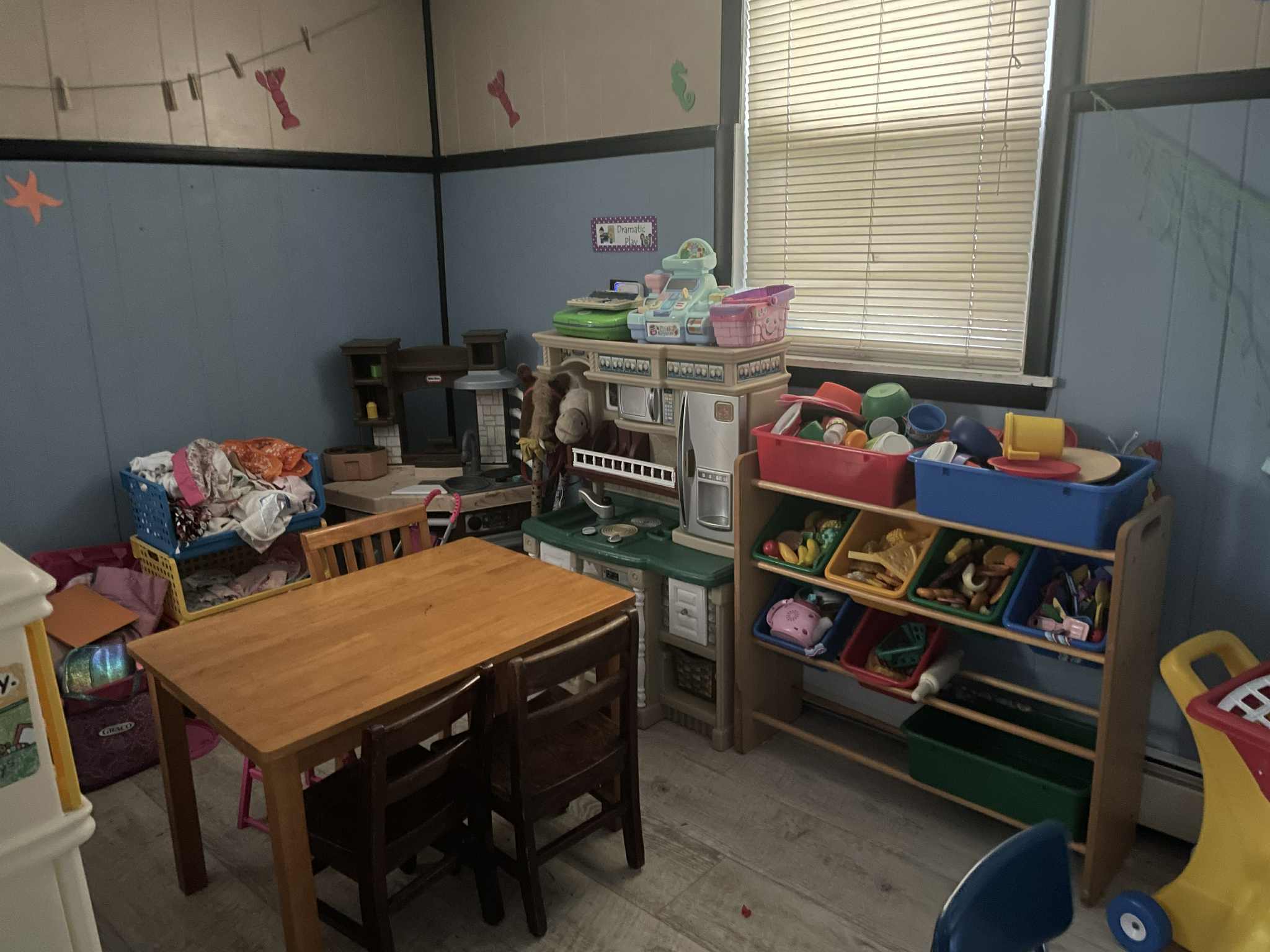Cozy play area with small tables and organized learning materials
